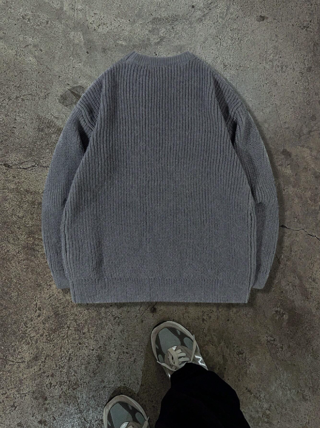 Lightweight, textured knit oversized sweater with a casual unisex style, featuring a minimalist design, relaxed loose fit, and classic crew neck